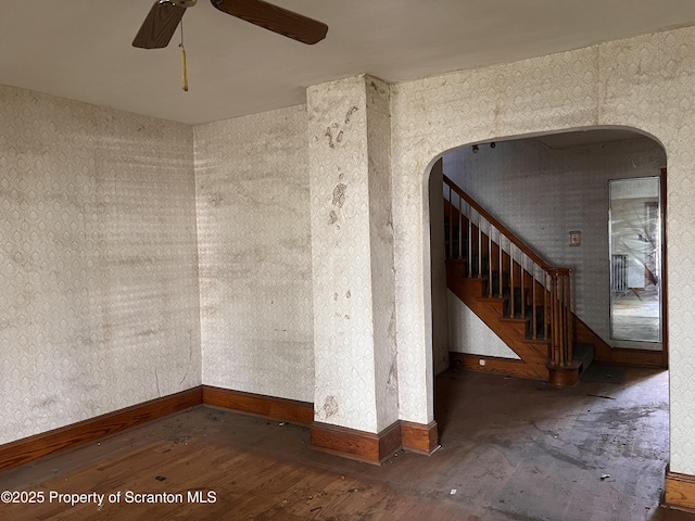 826 N Main St, Forest City, PA 18421 - unfurnished room featuring ceiling fan, wood finished floors, arched walkways, and stairway