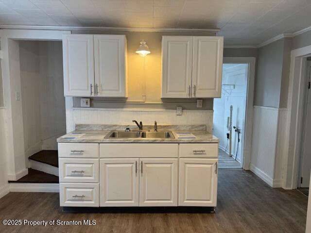 kitchen featuring dark hardwood / wood-style flooring, white cabinetry, and sink