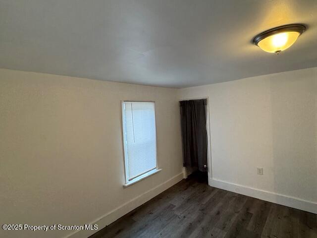 empty room featuring dark hardwood / wood-style floors