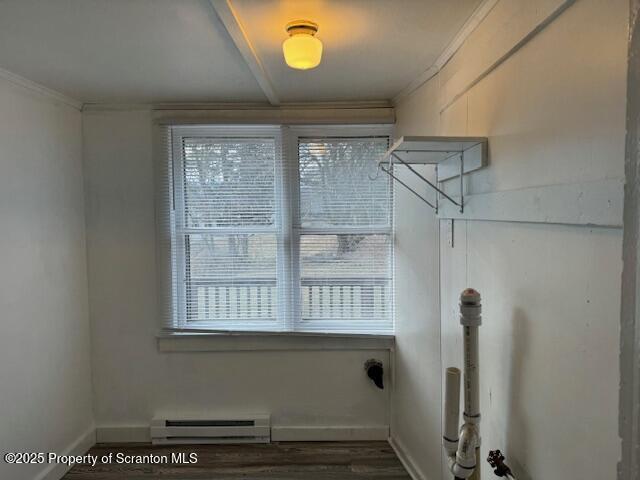 laundry area with baseboard heating and ornamental molding