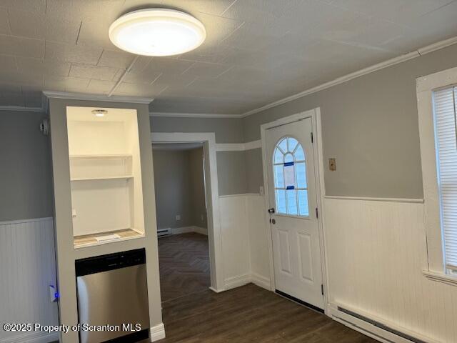 entrance foyer with dark hardwood / wood-style flooring, ornamental molding, and a baseboard heating unit