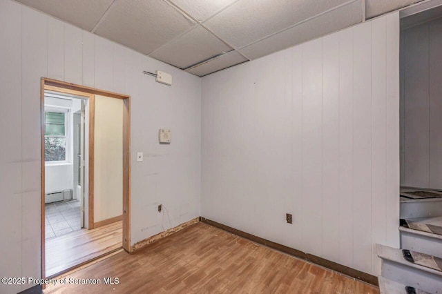 1725 Cedar Ave, Scranton, PA 18505 - empty room featuring light wood-type flooring, a drop ceiling, and a baseboard radiator