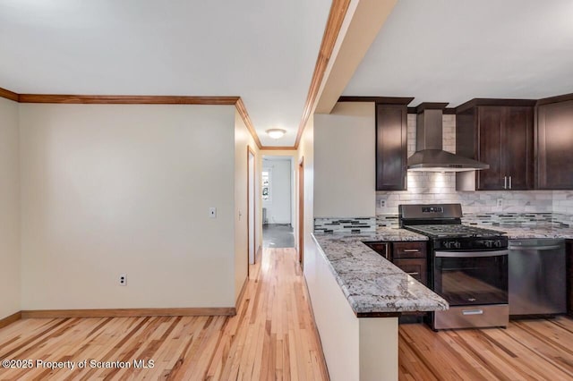 1725 Cedar Ave, Scranton, PA 18505 - kitchen with wall chimney exhaust hood, appliances with stainless steel finishes, dark brown cabinetry, light wood-style flooring, and decorative backsplash