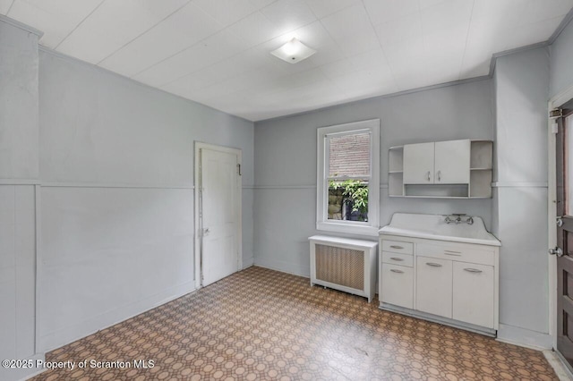 1725 Cedar Ave, Scranton, PA 18505 - kitchen featuring radiator, open shelves, light countertops, and light flooring
