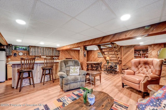 1107 Richmont St, Scranton, PA 18509 - living room with wood walls, a bar, light wood-style flooring, and a paneled ceiling