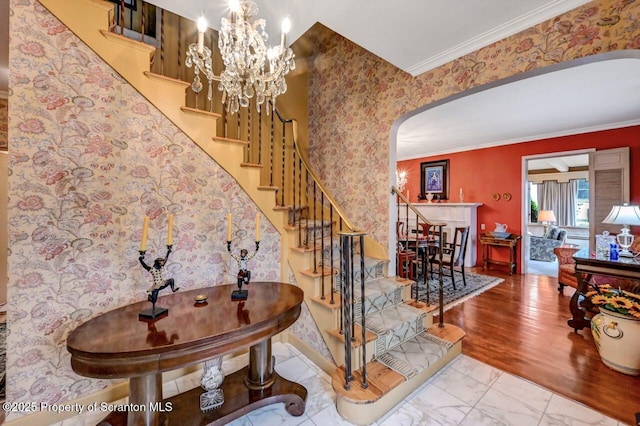 1107 Richmont St, Scranton, PA 18509 - stairs with arched walkways, ornamental molding, baseboards, wallpapered walls, and marble look tiles