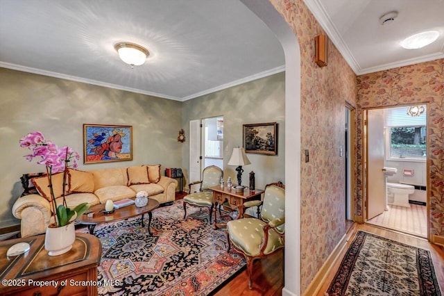 1107 Richmont St, Scranton, PA 18509 - living room featuring wood finished floors, arched walkways, ornamental molding, wallpapered walls, and baseboards