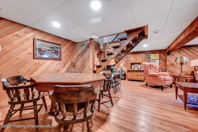 1107 Richmont St, Scranton, PA 18509 - dining space featuring wooden walls, a paneled ceiling, stairs, light wood-style floors, and a dry bar