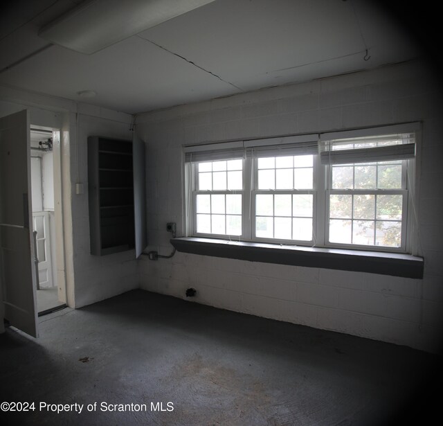 empty room featuring concrete block wall