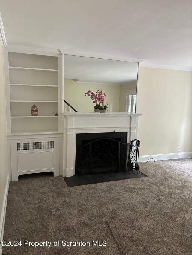 living room featuring carpet floors, a fireplace with flush hearth, radiator, and crown molding