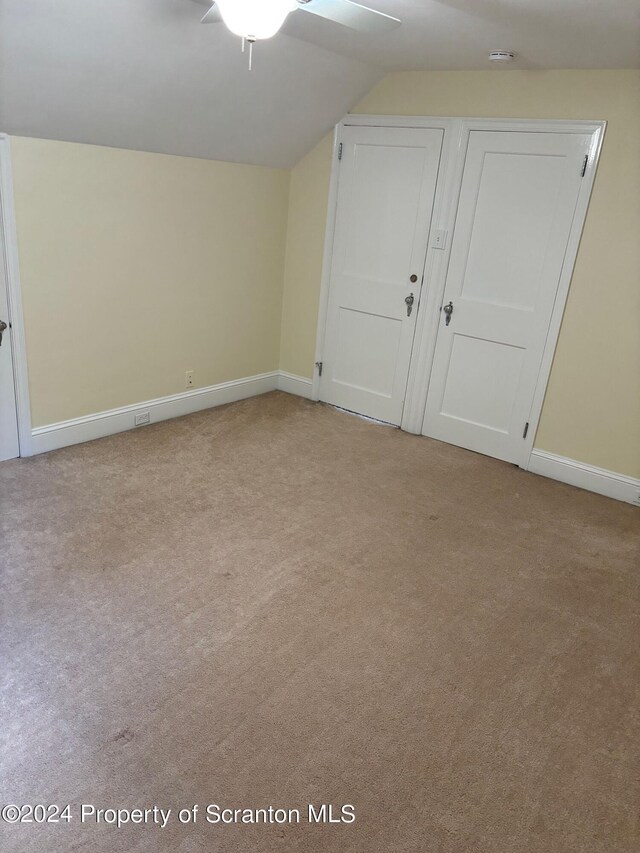 bonus room with baseboards, carpet, ceiling fan, and lofted ceiling