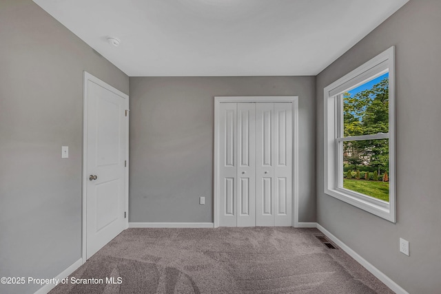98 Electric St Unit L 1, Clarks Summit, PA 18411 - unfurnished bedroom with multiple windows, carpet flooring, and a closet