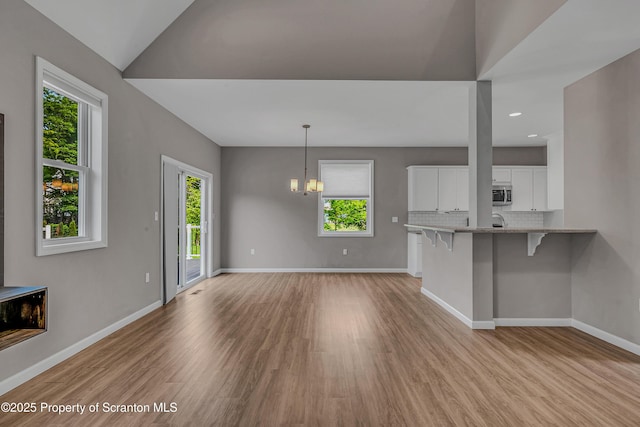98 Electric St Unit L 1, Clarks Summit, PA 18411 - unfurnished living room with light wood-style flooring, recessed lighting, and a chandelier