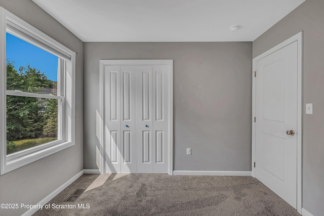 98 Electric St Unit L 1, Clarks Summit, PA 18411 - unfurnished bedroom with multiple windows, carpet flooring, and a closet