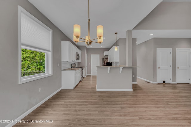 98 Electric St Unit L 1, Clarks Summit, PA 18411 - kitchen featuring stainless steel appliances, a chandelier, white cabinets, light wood-style floors, and recessed lighting