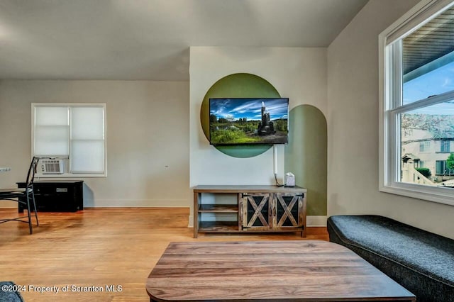 living room with cooling unit and hardwood / wood-style flooring