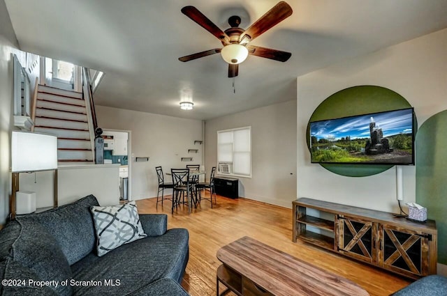 living room with ceiling fan and hardwood / wood-style flooring