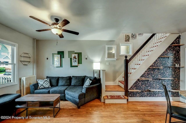 living room featuring ceiling fan and hardwood / wood-style flooring