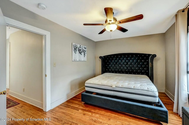 bedroom with hardwood / wood-style floors and ceiling fan