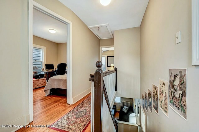 hallway with hardwood / wood-style floors