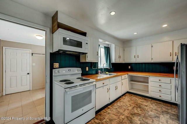 kitchen with white cabinets, white appliances, backsplash, and sink