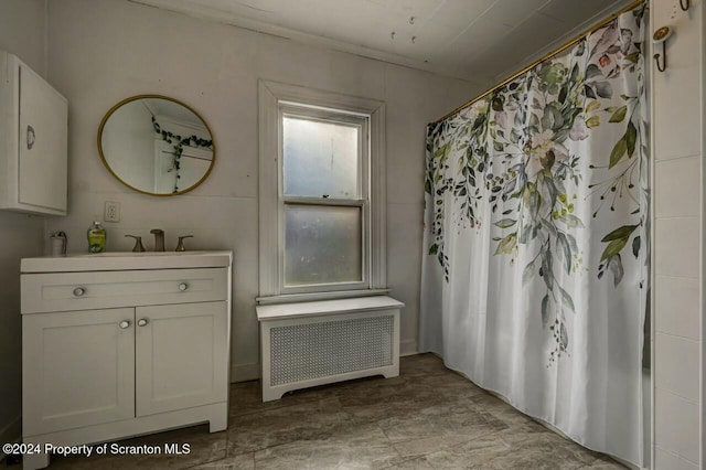 bathroom with radiator heating unit, vanity, and a shower with shower curtain