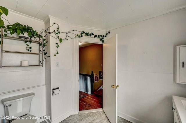 bathroom with toilet and crown molding