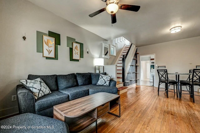 living room featuring ceiling fan and hardwood / wood-style flooring