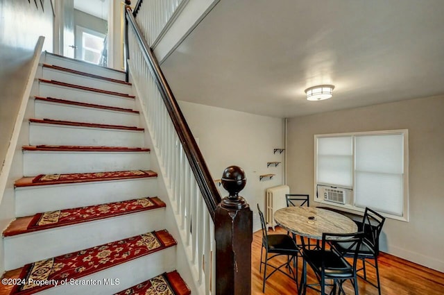 stairway with radiator heating unit, cooling unit, and wood-type flooring