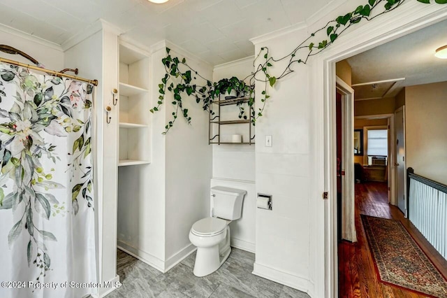 bathroom featuring hardwood / wood-style floors, toilet, and crown molding