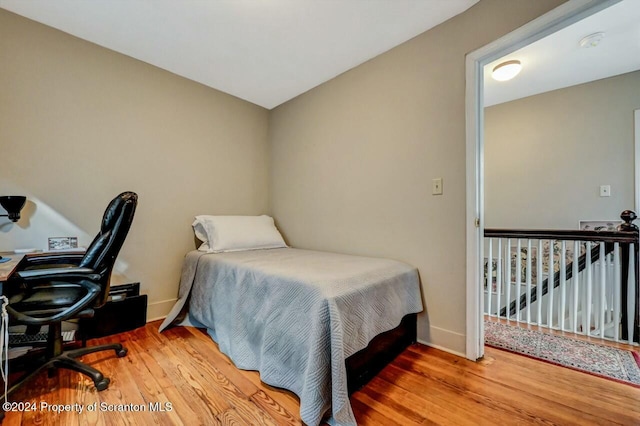 bedroom with hardwood / wood-style floors