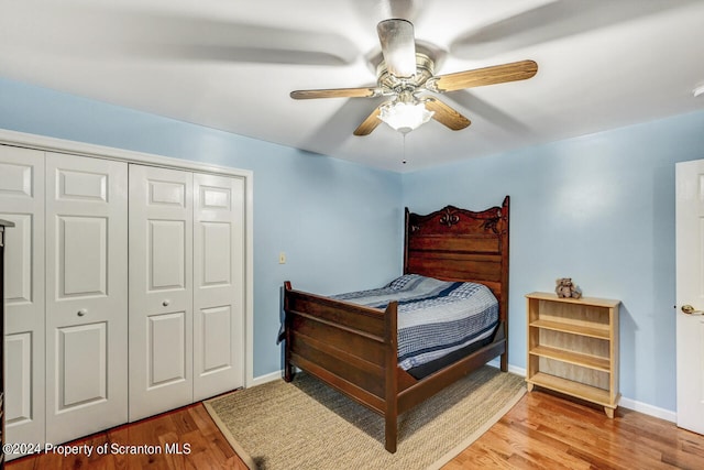 bedroom with ceiling fan, light hardwood / wood-style floors, and a closet