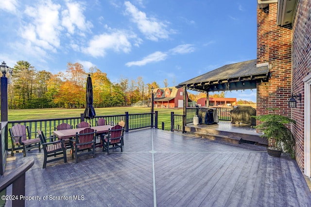 wooden deck featuring a yard