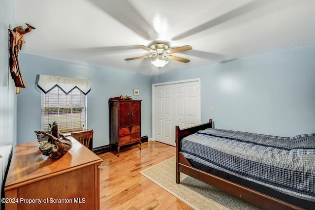 bedroom featuring ceiling fan, light hardwood / wood-style floors, and a closet