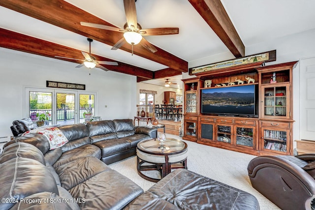 living room featuring beam ceiling, carpet flooring, and french doors