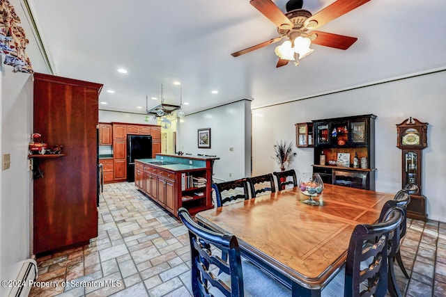 dining area with ceiling fan and a baseboard heating unit