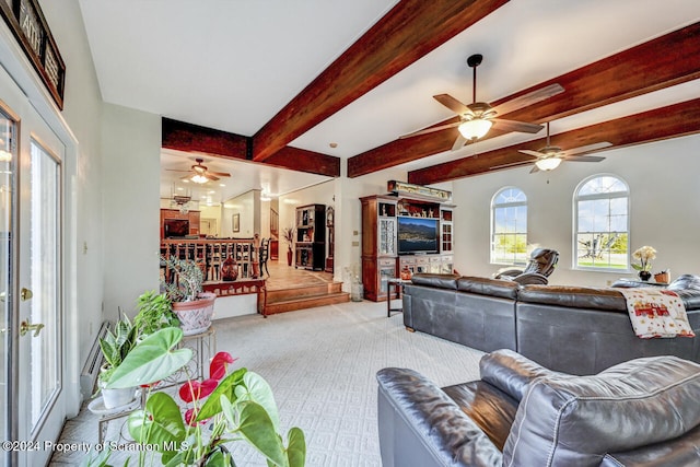 carpeted living room featuring ceiling fan and beamed ceiling