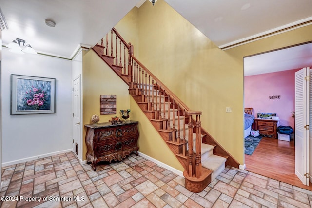 stairway featuring crown molding