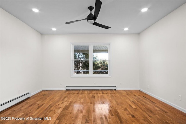 spare room featuring a baseboard radiator, a ceiling fan, recessed lighting, and wood finished floors
