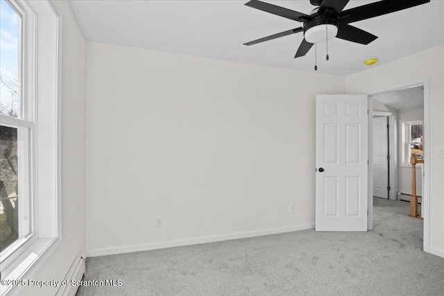 carpeted spare room featuring baseboards, a baseboard heating unit, and ceiling fan