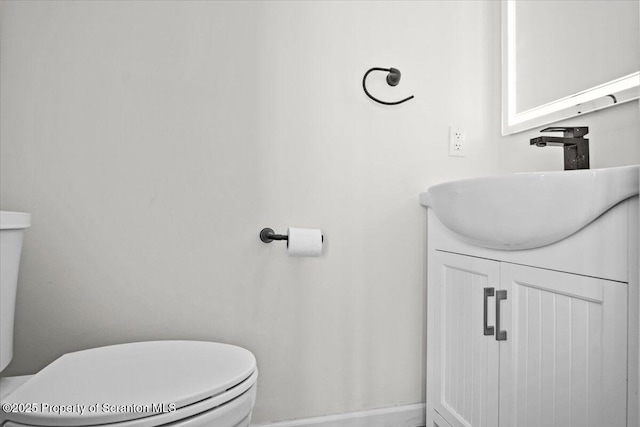 half bathroom featuring toilet and vanity
