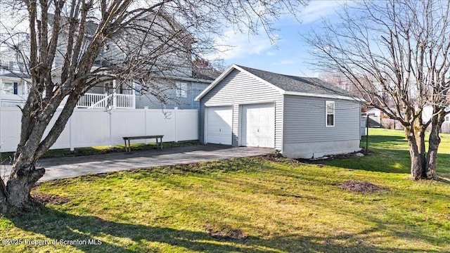 detached garage featuring fence
