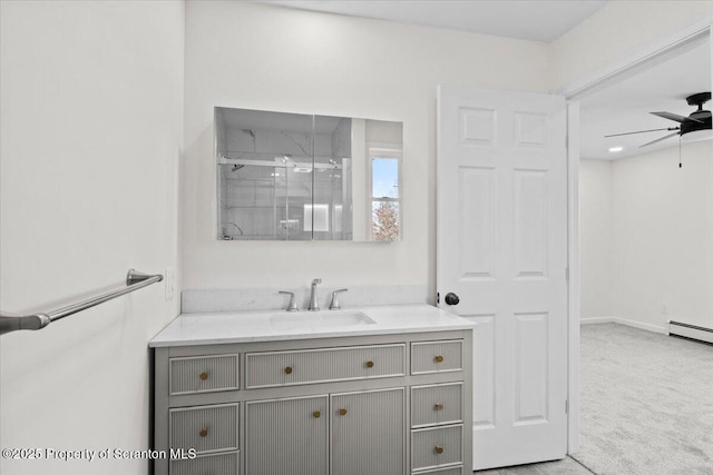 bathroom featuring a ceiling fan, vanity, and a stall shower