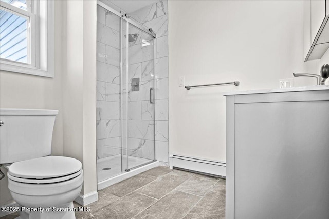 full bath with vanity, toilet, stone finish floor, a stall shower, and a baseboard radiator