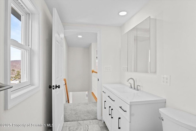 bathroom with plenty of natural light, recessed lighting, toilet, and vanity