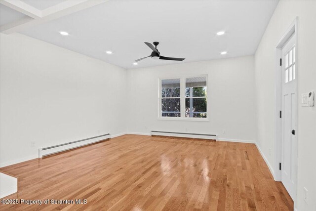 spare room featuring a baseboard radiator, a ceiling fan, recessed lighting, and wood finished floors