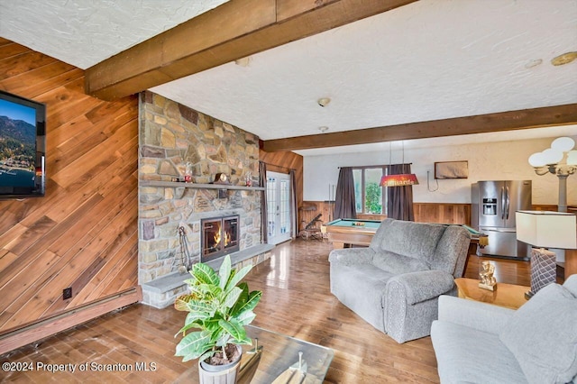 living room with beamed ceiling, wood walls, and pool table