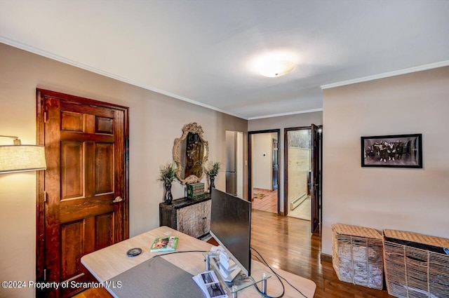 office space featuring ornamental molding, a baseboard radiator, and hardwood / wood-style flooring