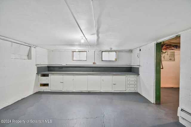 basement featuring a baseboard heating unit