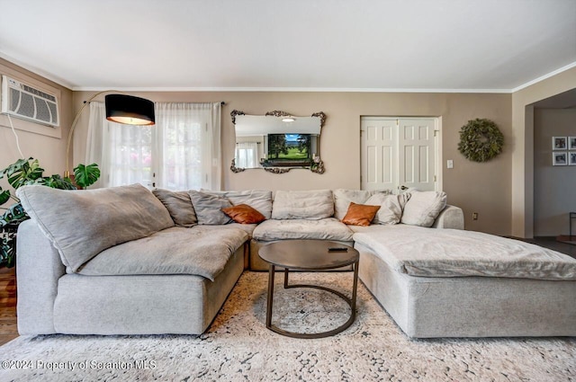 living room with hardwood / wood-style flooring, a wall mounted air conditioner, and ornamental molding